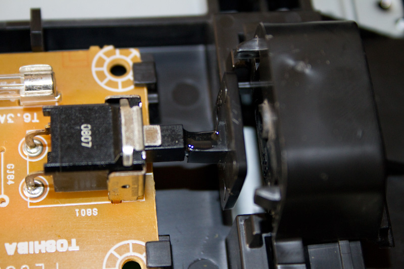 The plastic piece glued back in place